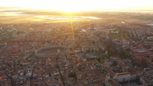 Aerial back traveling over Arles amphitheater arena France sunrise 