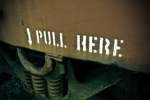 Pull Here and arrow sign on the side of a box car