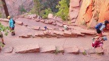 Springdale, Utah, USA - October, 2022: Crowds gather to hike up to Angels Landing, a popular and dangerous hike in Zion National Park. 
