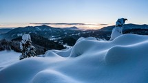 Sunset over snowy nature in cold winter mountains landscape time lapse
