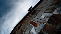 Side of rusty metal building.