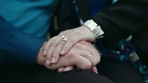 senior couple holding hands 