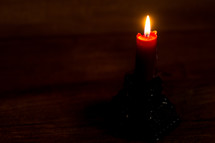 a candle stick with a wood background