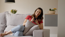 Woman using smartphone. Happy caucasian female enjoy online chat, internet purchase, browse web, download new cool freeware application. Modern wireless tech user concept 
