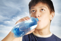 boy drinking bottled water 
