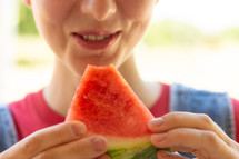 a woman eating watermelon 