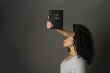 an arm holding a Bible reaching through a woman's head 

"Do not conform to the pattern of this world, but be transformed by the renewing of your mind" Romans 12:2