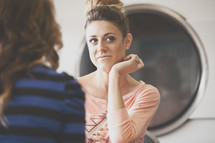 women in conversation at a laundromat