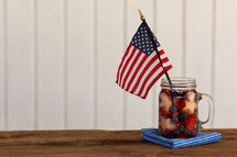 American flag in a mason jar glass of berry tea 