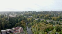 aerial view over a river and brick building 