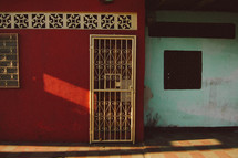 barred doors and windows on a red house 