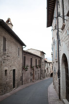 An alley between rows of old stone buildings.