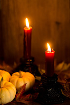 a candle with fall pumpkins