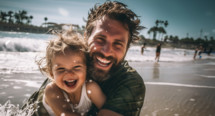 Father and child on the beach smiling and having a good time