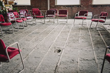 old abandoned building with empty chairs in a circle