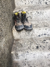 set of boots left on steps free to whomever needs them