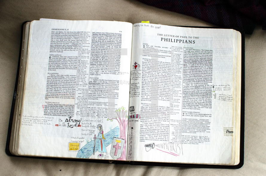 handwritten notes on the pages of an opened Bible - Philippians