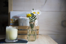 daisies in a vase and candle 