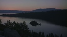 Timelapse of a lake as the sun rises over mountains