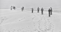 people walking on a beach in winter 