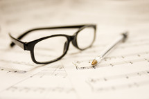 sheet music and reading glasses