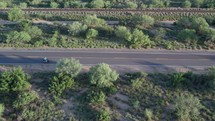 Aerial of people riding e-bikes on a country road