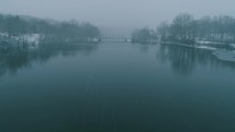 falling snow over a river 