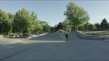 Young Man Gets Big Air on Skateboard at Skate Park