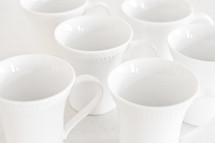 white coffee cups against a white background 