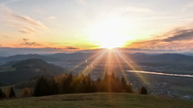 Time Lapse of sunrise over small city in alpine mountains on autumn morning in Europe. 
