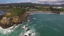 Aerial Video of Ocean Rock Formation and Coastal Town