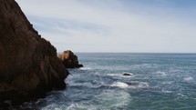 rocky cliffs along a shoreline 