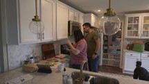 Married couple making dinner in the kitchen