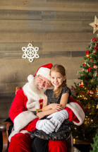 girl sitting on Santa's lap 