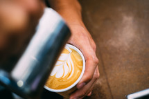 heart shaped creamer in a latte 