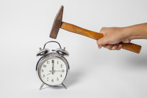 taking a hammer to an alarm clock 