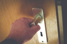 hand on a door handle 
