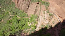  A group of hikers walking up to the top of Angel's landing in Zion National Park
