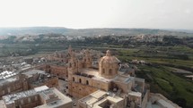 Aerial 4k drone footage revealing an old fortified city in the Northern Region of Malta called Mdina along the Mediterranean Coast.
