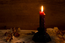 a candle with leaves and music