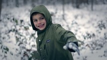 a kid throwing a snowball 