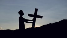 a man holding a cross 