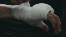a boxer wrapping his hands with tape 