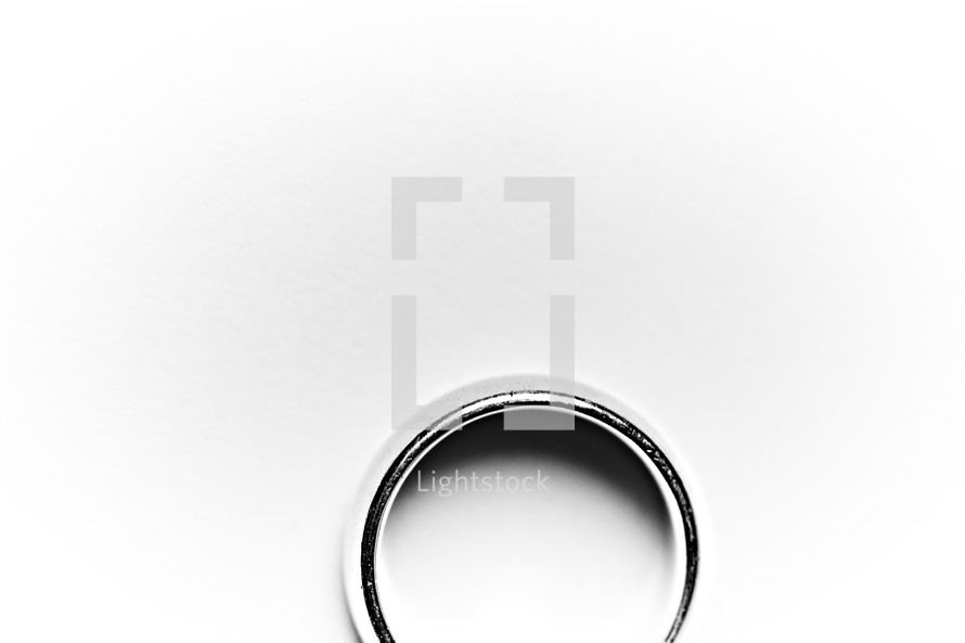 A husband's wedding band or ring isolated on white