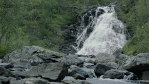 water cascading over rocks down a mountainside 