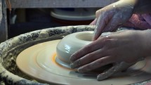creating pottery on a potters wheel 