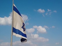 Flag of Israel waving against blue sky