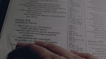  Man turns pages and reads Psalm 23