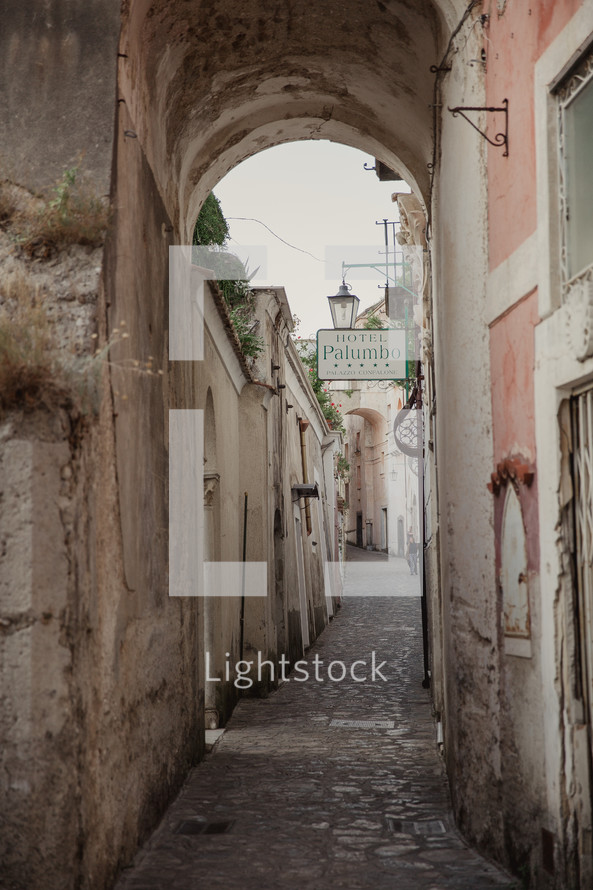 narrow street and hotel sign in Italy 