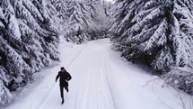 man jogging in snow 
